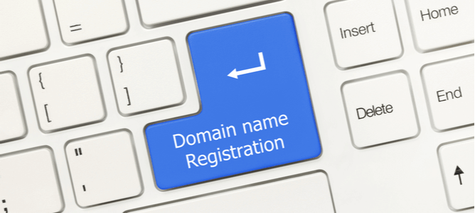 Close-up view on white conceptual keyboard - Domain name registration (blue key)