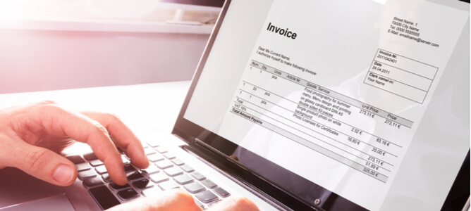 A man compares a digital invoice with her accounts payable on laptop