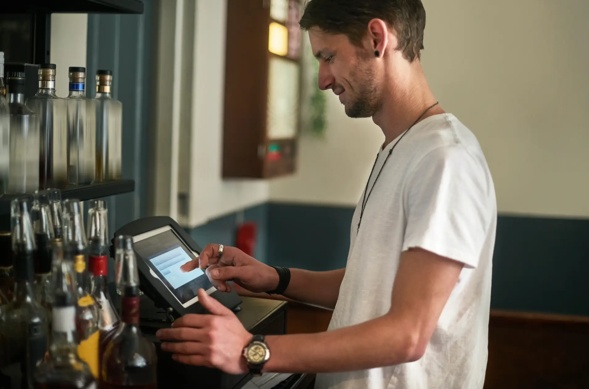 manager at a liquor store ringing up a client