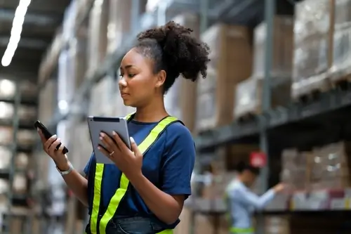 warehouse worker managing inventory with a POS system